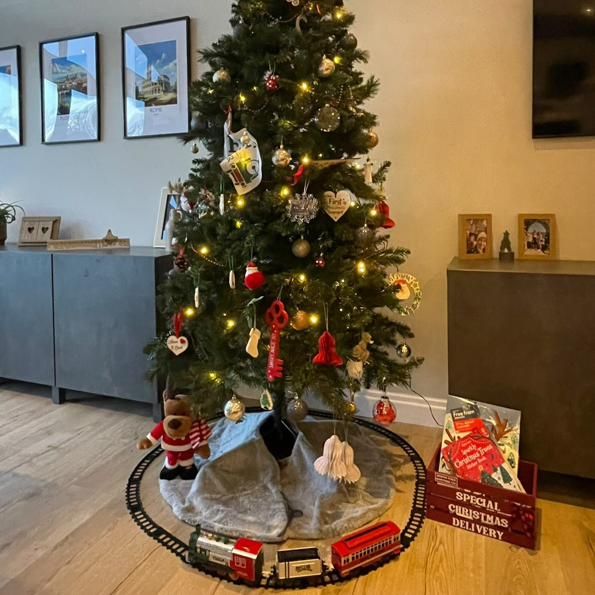 christmas tree with gold baubles and train set at the bottom