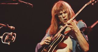 Steve Howe pulls a serious guitar gurn as he takes a solo onstage with Yes