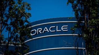 A telephoto shot of the Oracle logo displayed on the side of the Oracle offices in Redwood City, California.