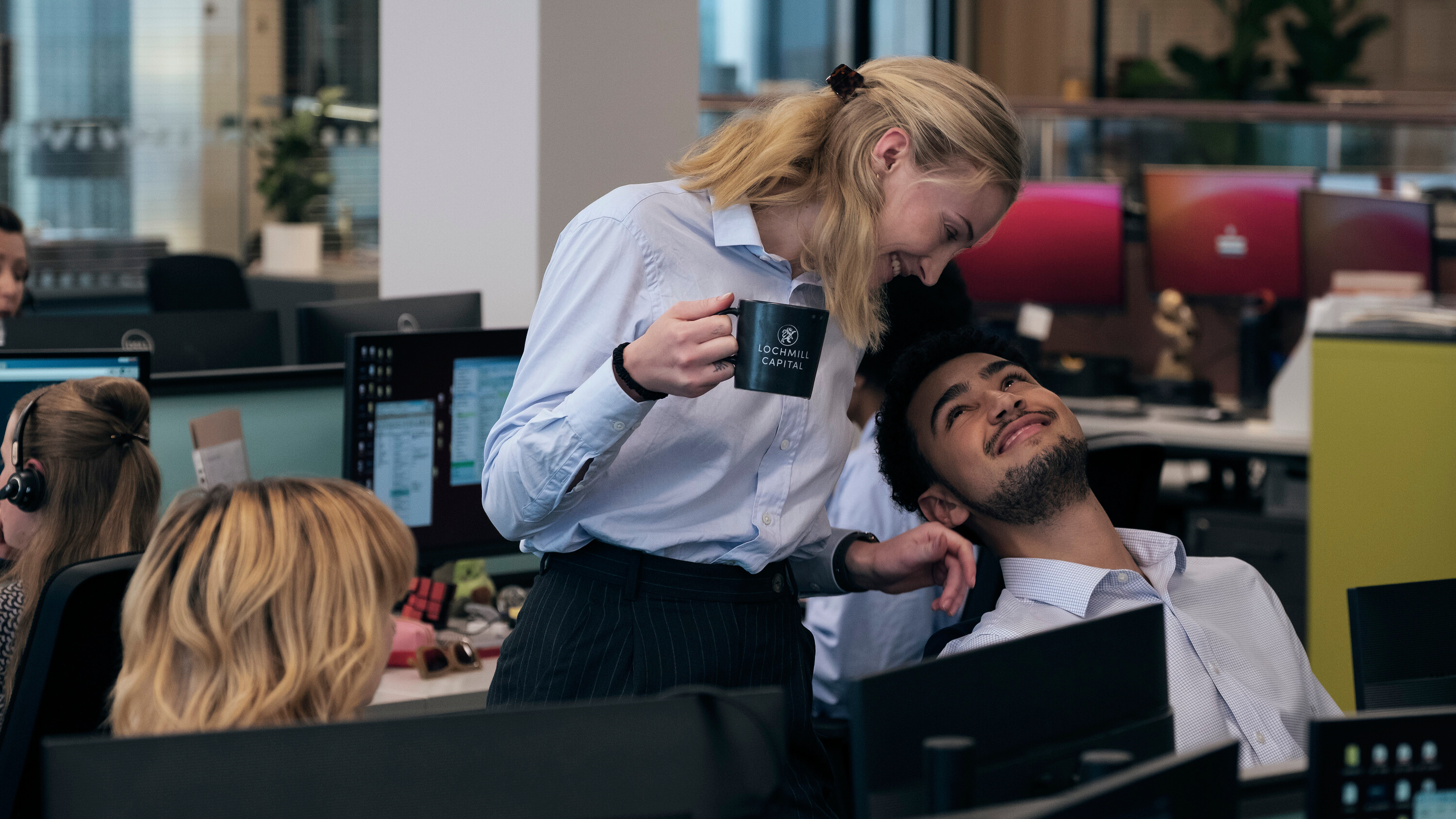 L-R: Myrtle (Eloise Thomas), Zara (Sophie Turner) and Luke (Archie Madekwe) at their desks in Prime Video's &amp;quot;Steal&amp;quot;