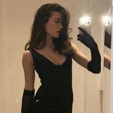 A woman taking mirror a selfie with voluminous, textured hair.