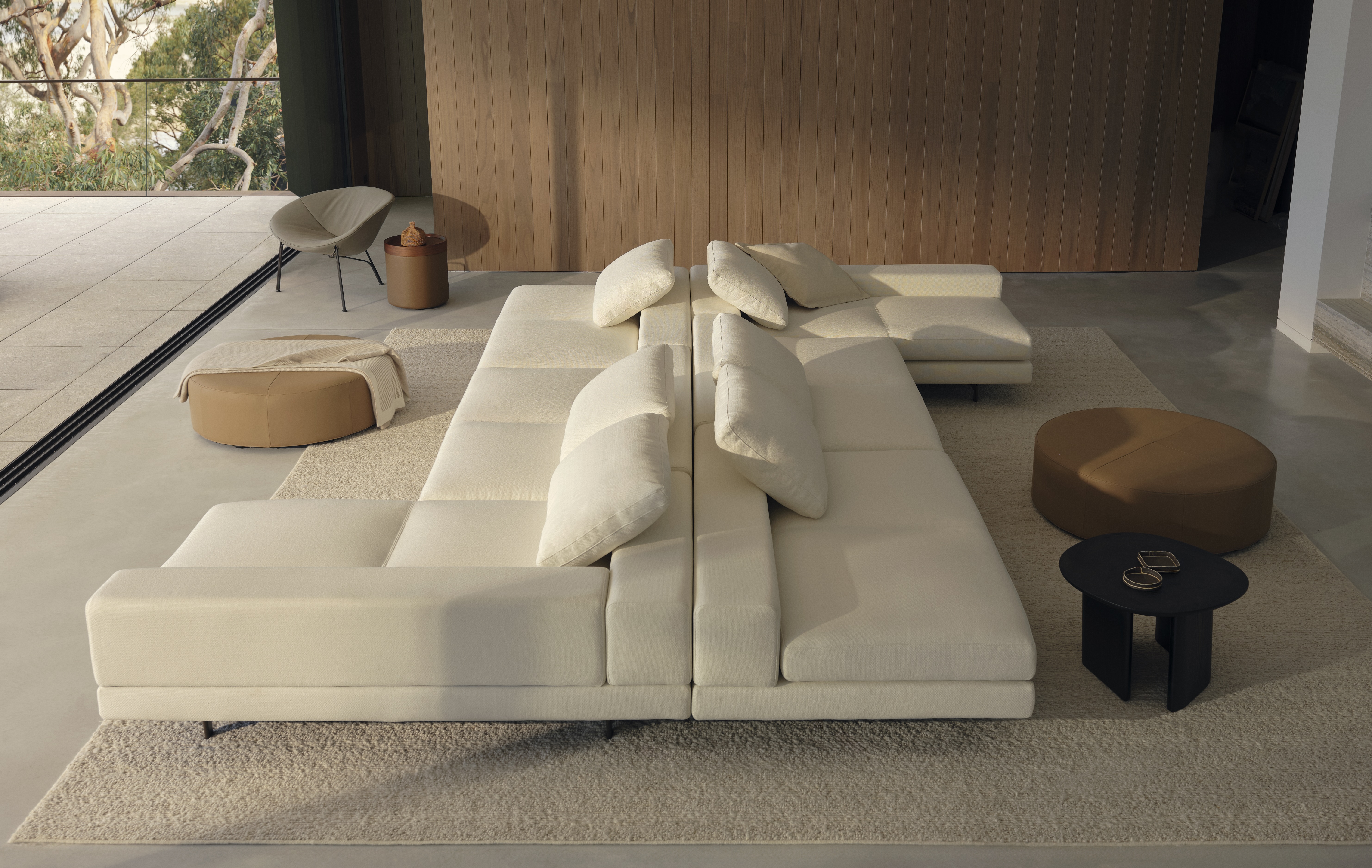 A sofa island made with two back-to-back white sofas.