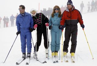 Prince Charles, Princess Diana, Sarah Ferguson and Prince Andrew standing with ski poles in the snow in 1987