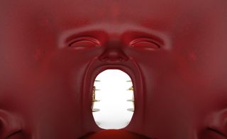 Interior view of Novembre’s room installation which is red and features eyes, a nose and a mouth which is the entrance offering a partial view of the two gold statues outside