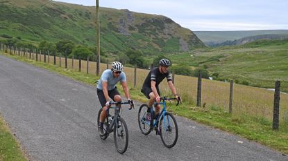 Image shows two riders completing cycling training plans for fitness gains