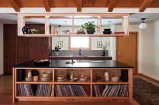 A kitchen island with storage above and below the island
