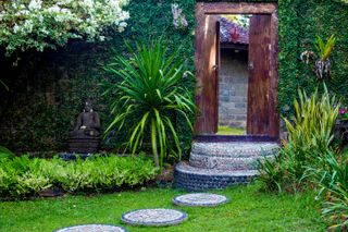 stepping stone ideas: mosaic stones leading to steps and gate