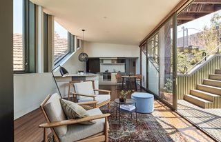 The kitchen and dining area of the new house is at first floor level, with stairs at right leading up to the roof terrace