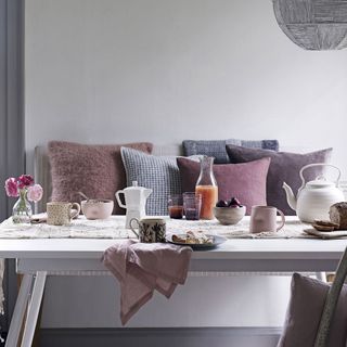 breakfast table and bench with laid-back palette soft purples pinks and greys