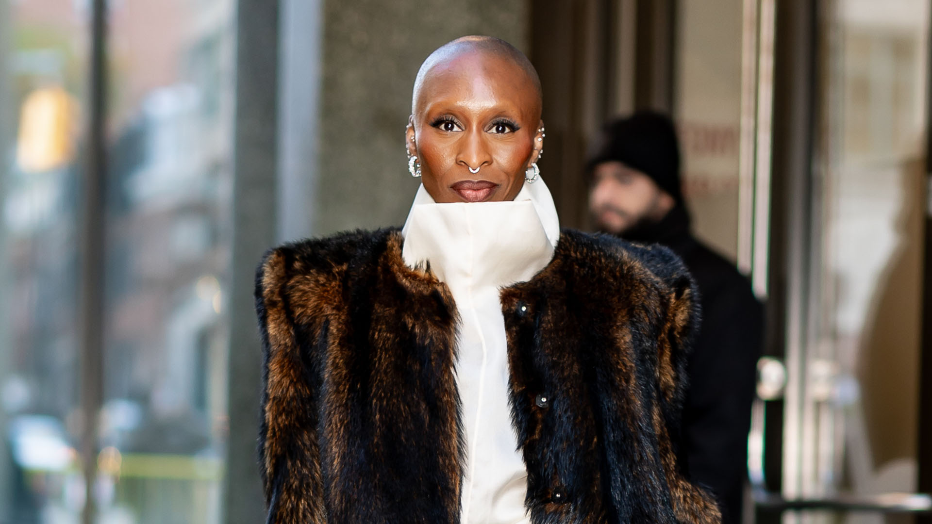Cynthia Erivo wearing a fur coat and black boots