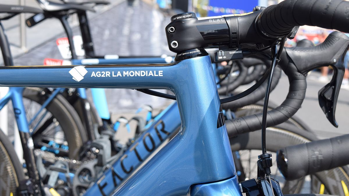 White team decals appear at the head of the top tube