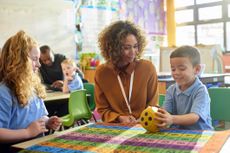 Teacher with school kids in classroom