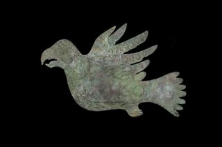 A copper cutout of a stylized bird, made by the people of the Hopewell Culture over 2,000 years ago. This copper effigy was recovered from the grounds of Hopewell Culture National Historic Park during the 1920s.