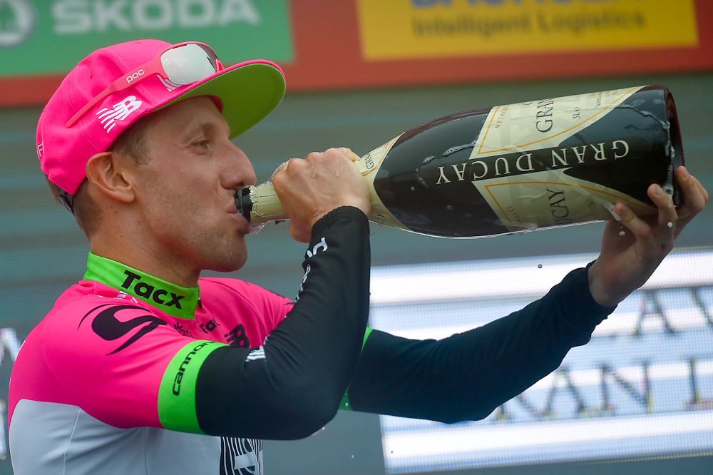 Michael Woods celebrates on the Vuelta podium after winning stage 17 in Balc&oacute;n de Bizkaia