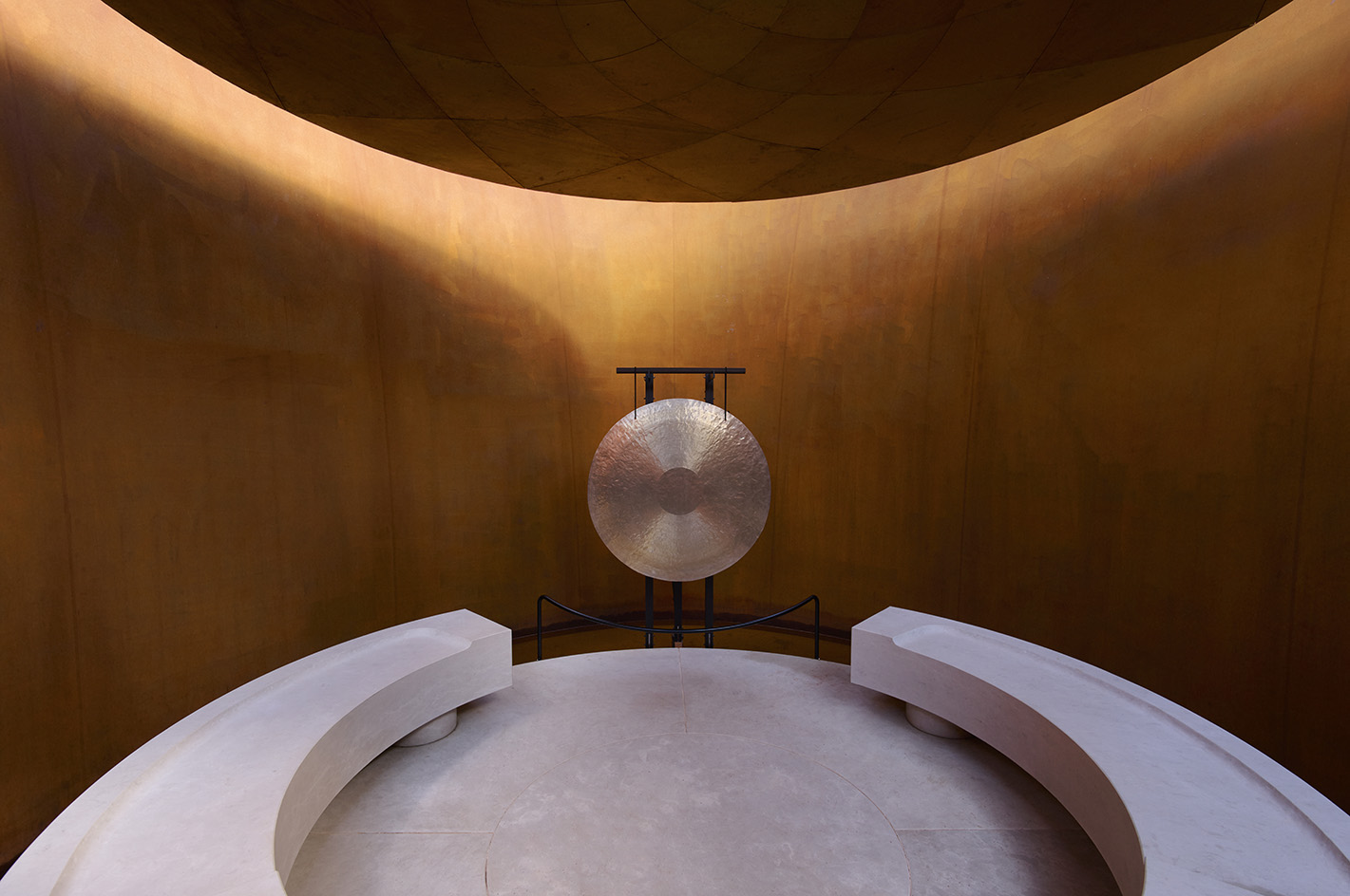 Doshi Retreat at Vitra, a pavilion made of corten steel and minimalist forms seen in the green countryside