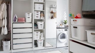 white utility room with appliances and storage