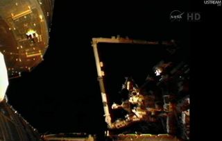 Japanese astronaut Akihiko Hoshide on the end of the space station's robotic arm.