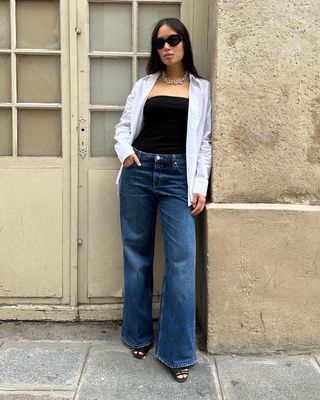 Anne pairs her flared jeans with a bandeau, open shirt and sandals.