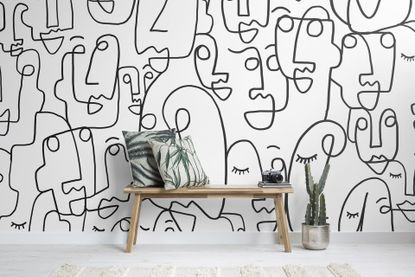 Monochrome wall mural with abstract faces pattern 