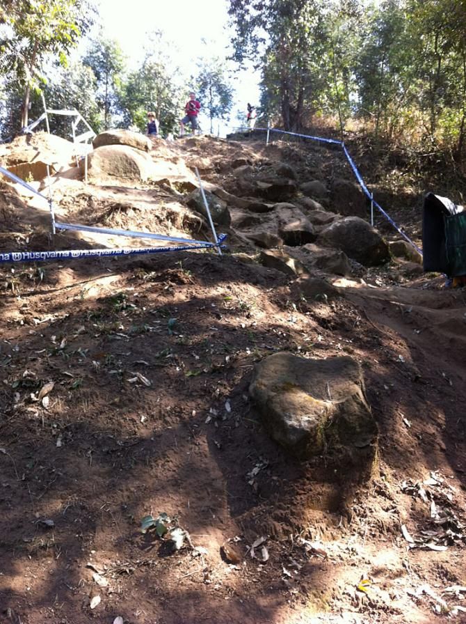 This steep, rocky drop is the most technical part of the downhill course. There are a few lines from which to chose. One rider looks over the edge during the track walk.