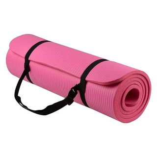 A rolled-up pink thick yoga mat with black straps.