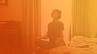 best exercise for sleeping: woman meditates on bed