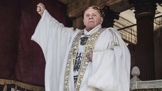 Anthony Hopkins wearing white robes as Vespasian in Peacock Original "Those About to Die"