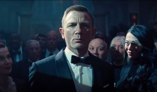 No Time To Die Daniel Craig surrounded by staring onlookers