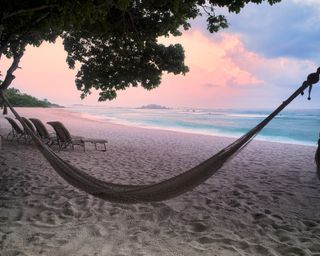 Sunset on beach with hammock at Punta Mita, Mexico