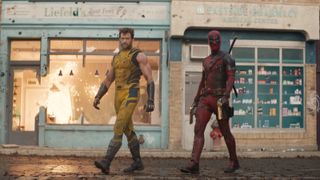 Wolverine and Deadpool striding in front of some wrecked shops.