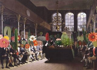 People seated holding giant flowers