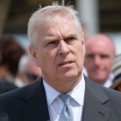 Prince Andrew has gray hair and looks pensive while wearing a suit