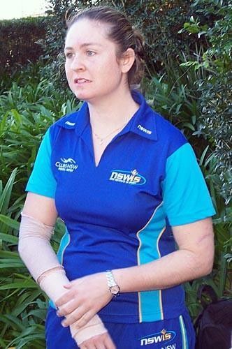 Kate Nichols holds her bruised and battered right arm