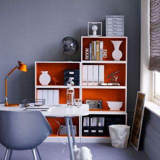 grey home office with modern orange book shelves