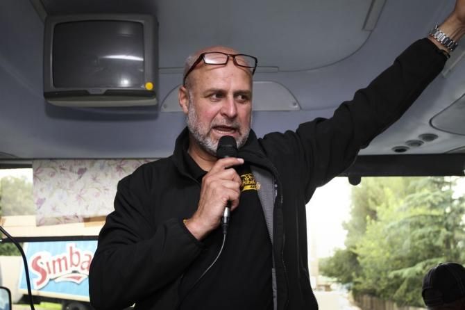 Qhubeka founder Anthony Fitzhenry prepares the riders for their delivery