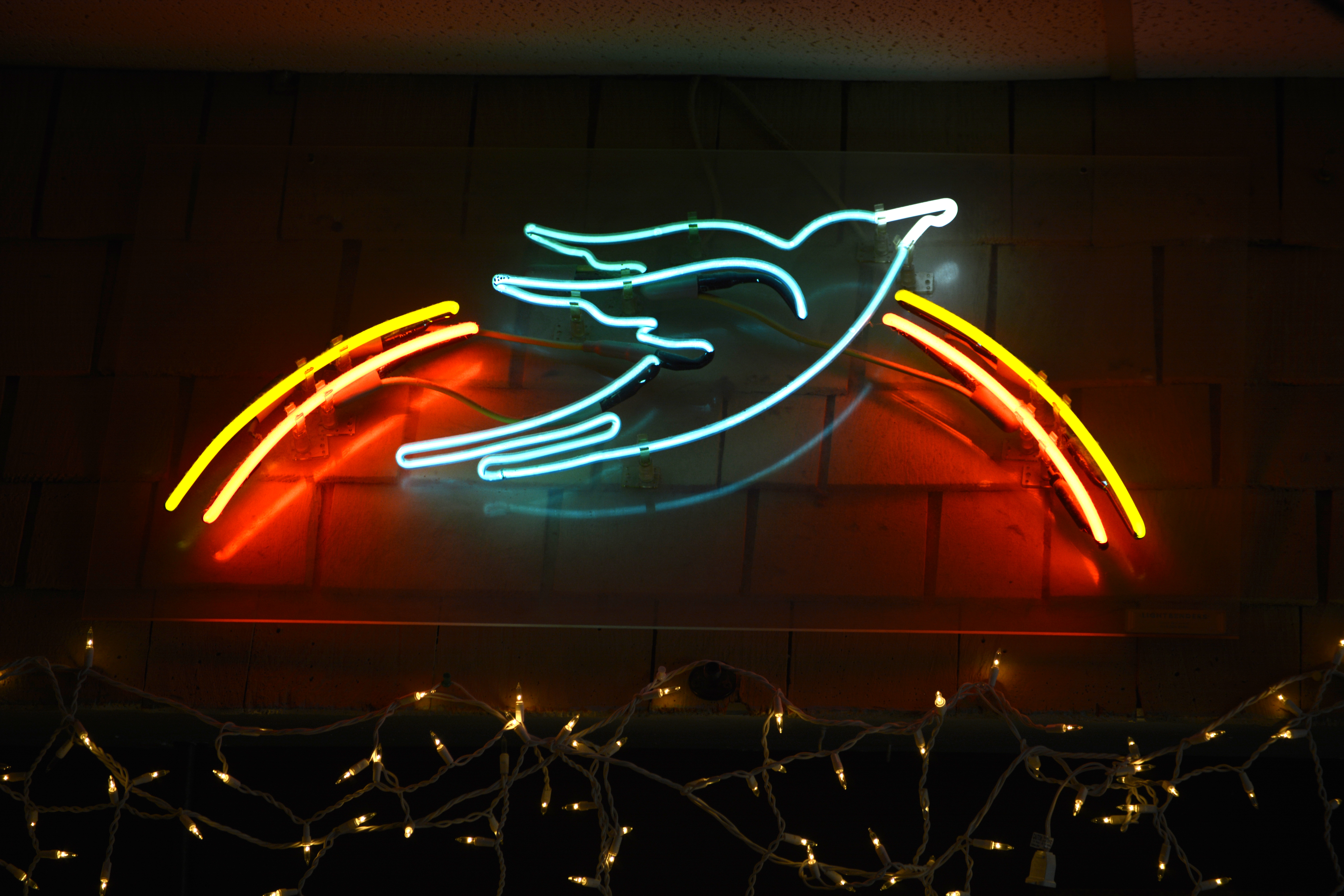 A neon bluebird above the stage at Nashville's Bluebird Cafe