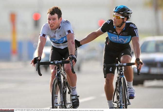 Mark Cavendish is helped by a teammate after crashing on stage 6 of the 2012 Tour of Qatar