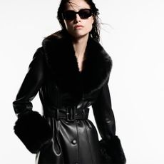 Model wearing a black faux leather coat