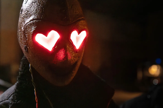 a killer in a mask with red heart eyes in the movie heart eyes