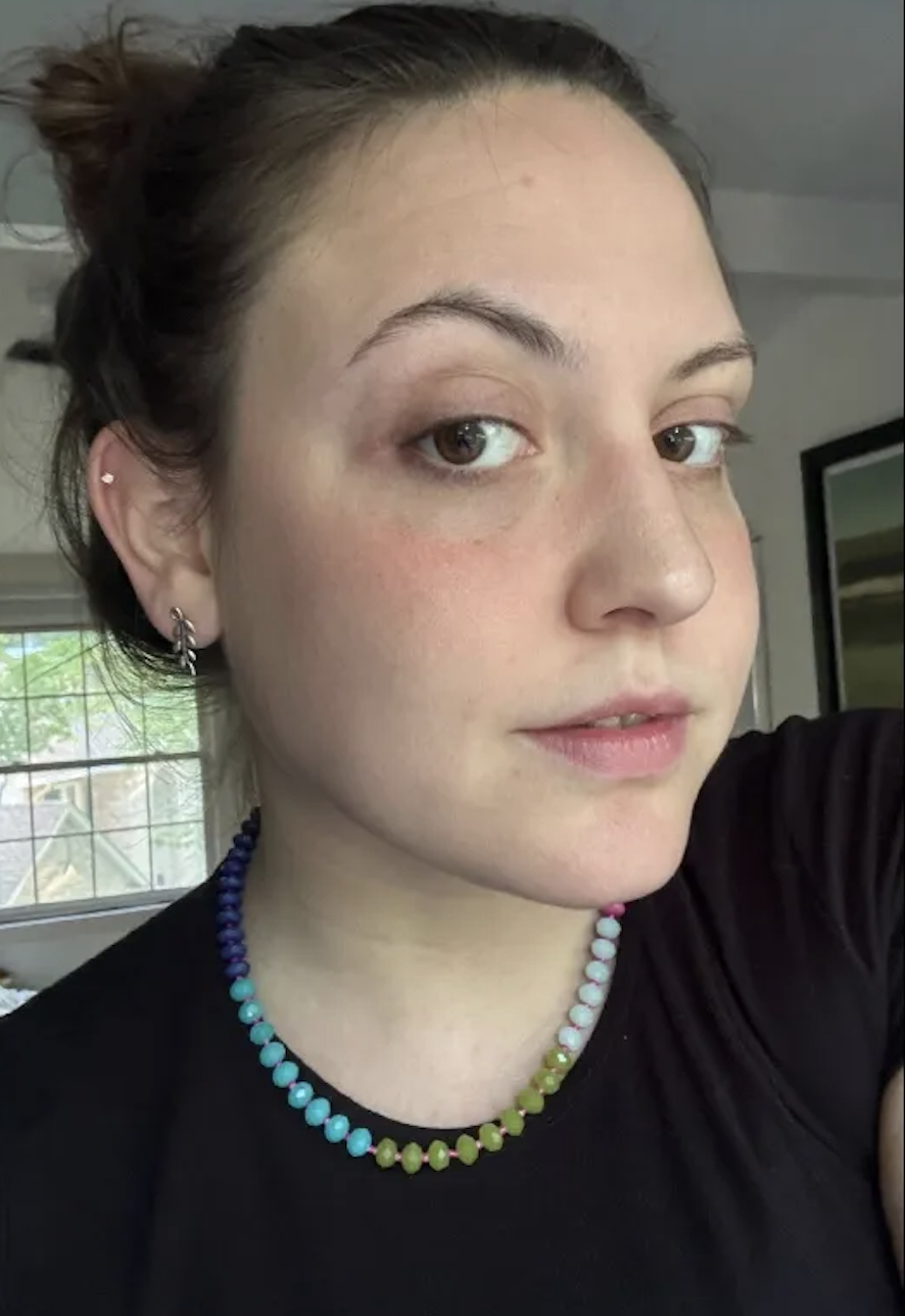 a girl with a black tshirt and clear skin before using the Anastasia Beverly Hills Beauty Balm Serum Boosted Skin Tint.