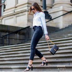 melbourne, australia may 2 fashion blogger holly titheridge wearing black sunglasses, a white topshop button shirt, black topshop denim jeans, black alias mae heel sandals, black yves saint laurent bag on may 2, 2016 in melbourne, australia photo by christian vieriggetty images