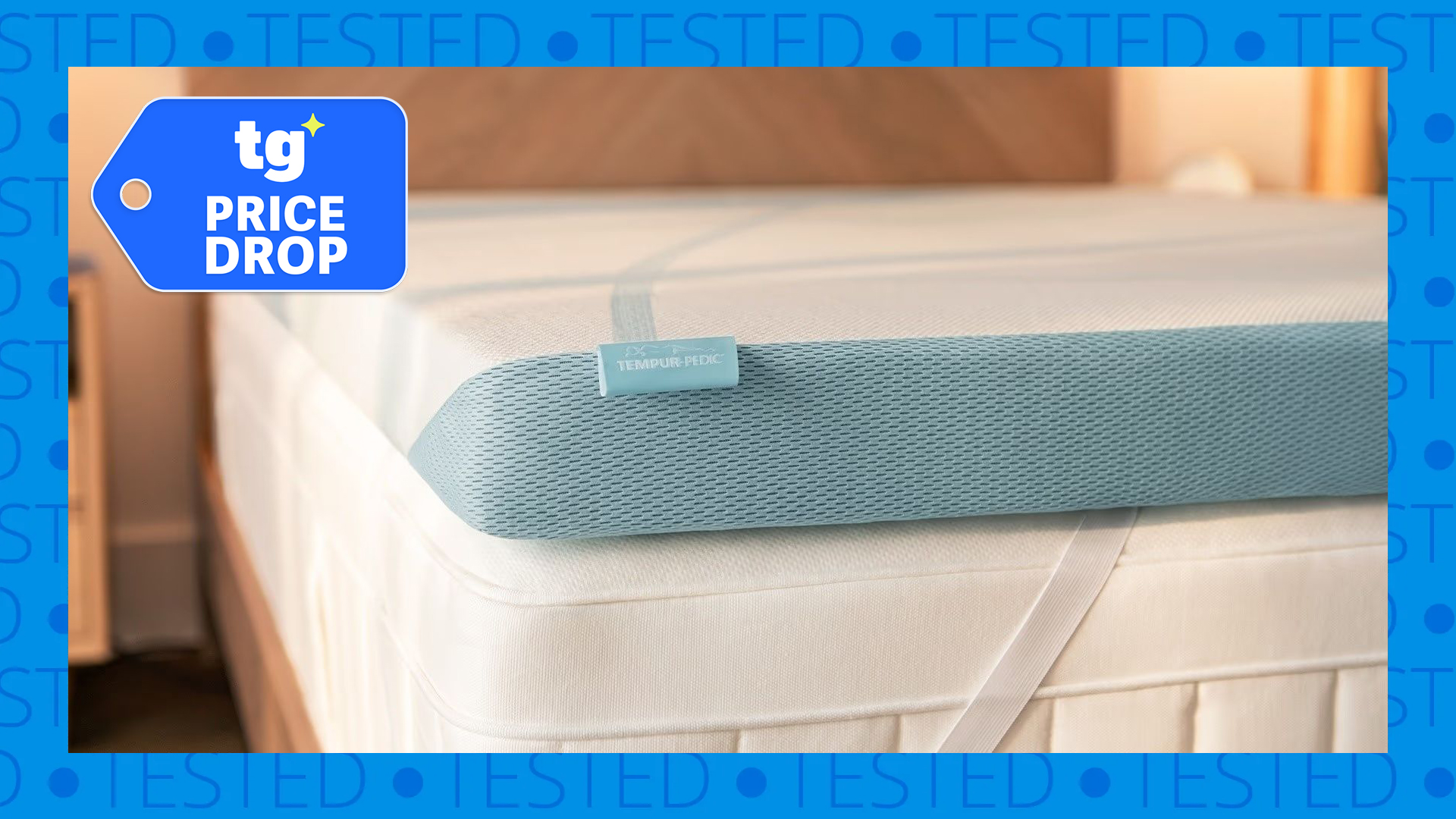 A close up of the Tempur-Pedic Tempur-Adapt mattress topper on a bed, with a Tom's Guide price drop badge in the top left corner