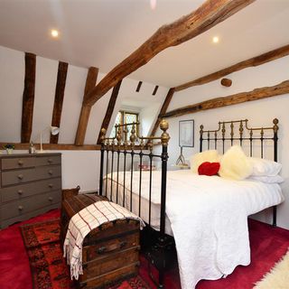bedroom with white wall and wooden beam
