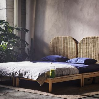 bedroom with grey wall and woven rattan headboard