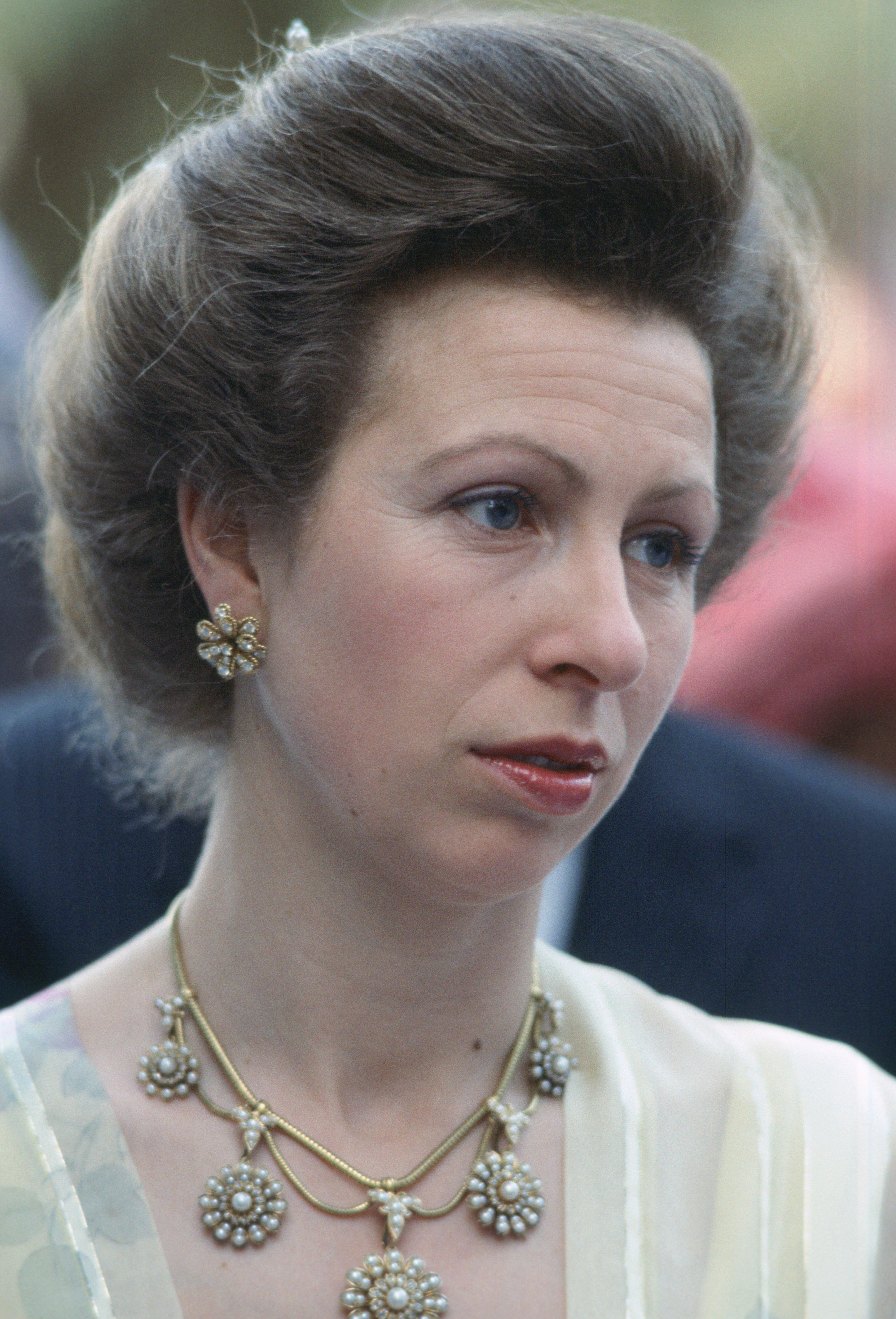 Princess Anne wearing a yellow dress and statement necklace in 1984