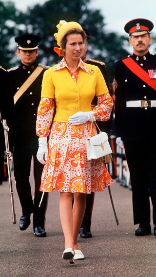 Princess Anne wearing a bright orange and yellow outfit