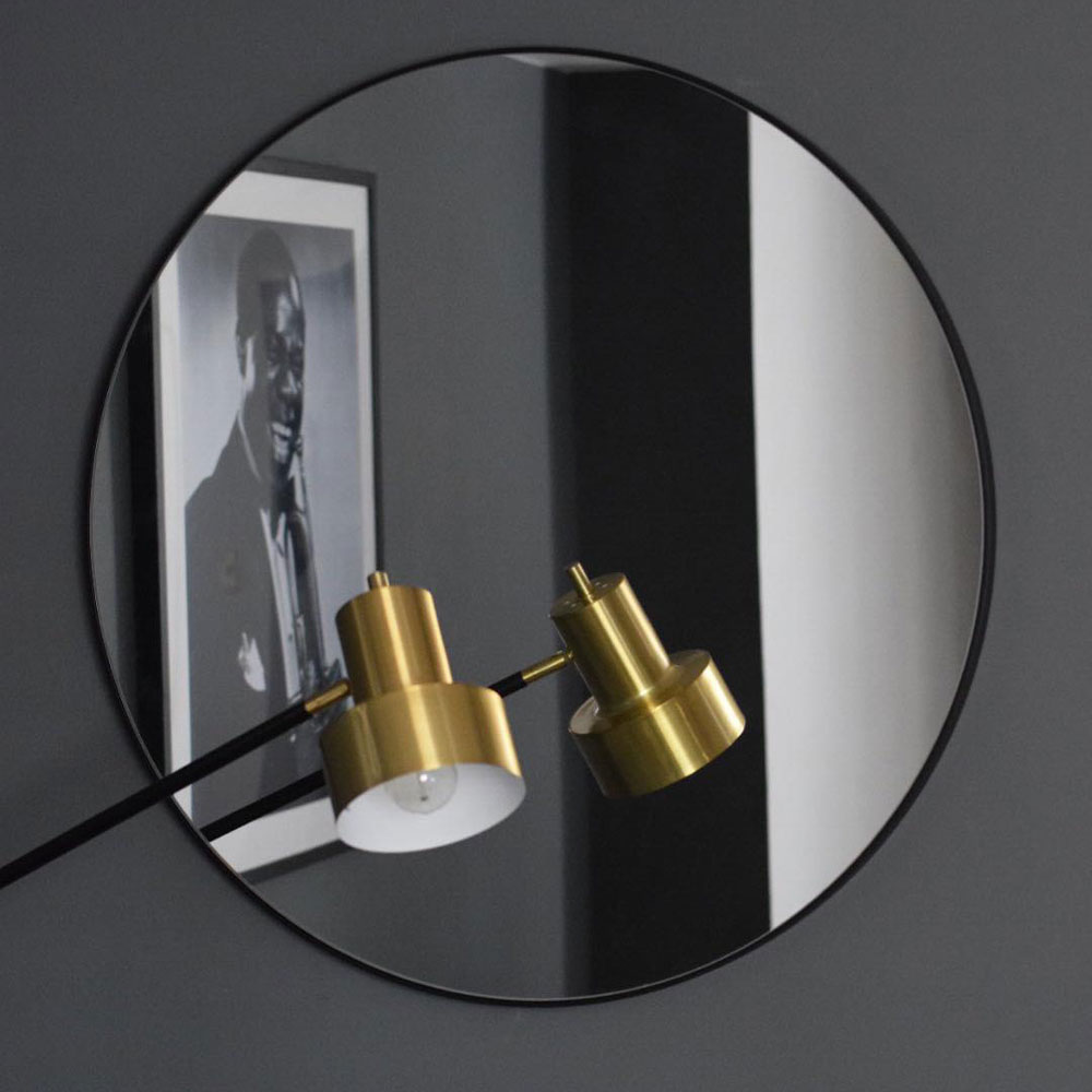 charcoal wall with mirror and lamp