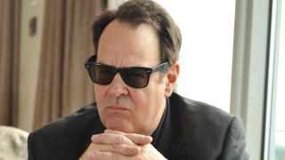 Dan Akyroyd posing for a photograph in sunglasses