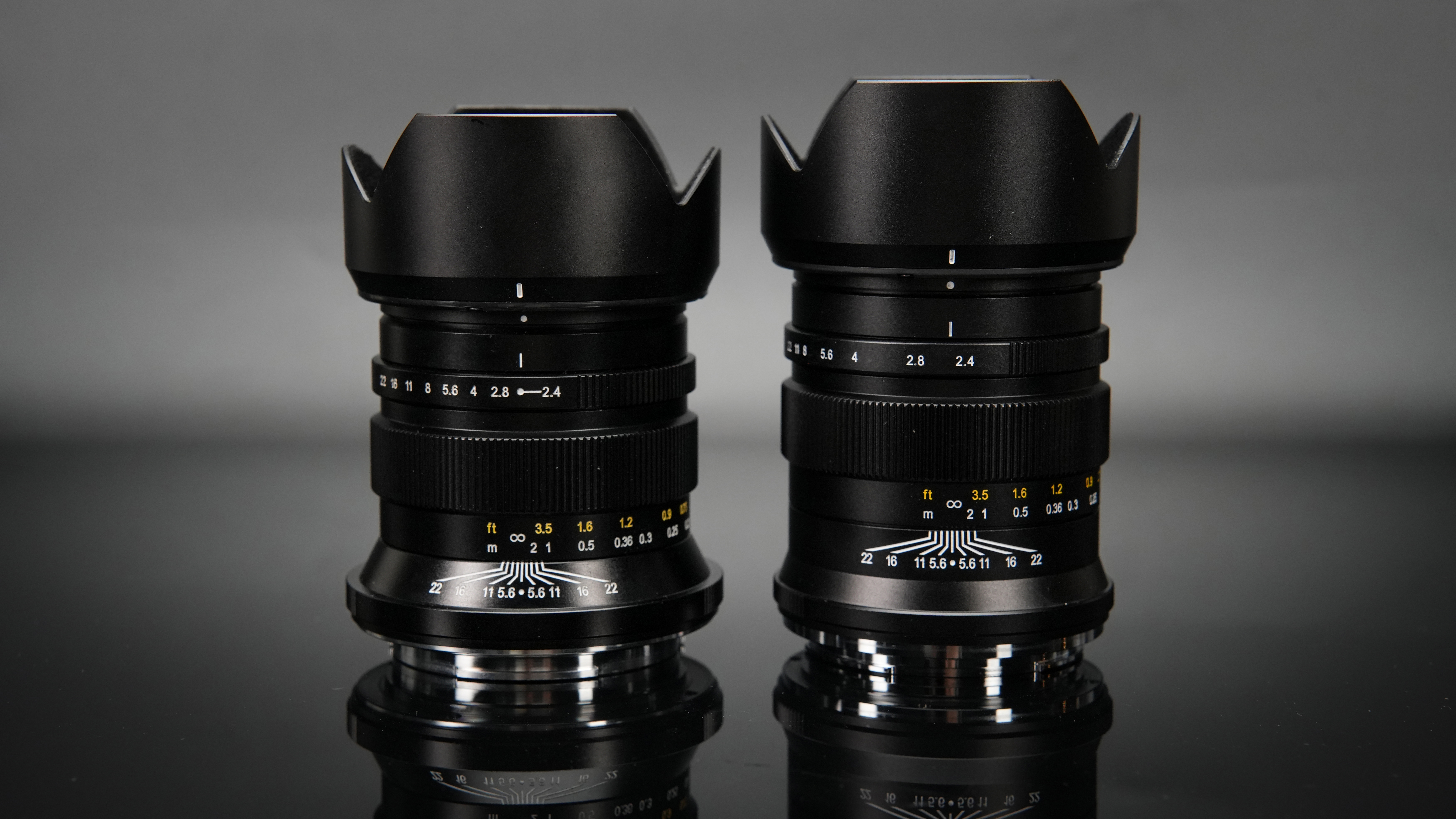 ZY Optics Pittura 30mm f/2.4 lens in GFX and XCD mount against a dark background