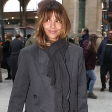 Halle Berry wears a gray coat with a gray scarf.